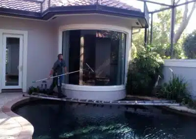 Skilled Professional Expertly Cleaning Curved Glass Window