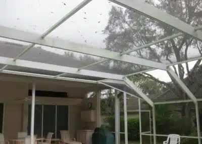 A patio with a table and chairs in the middle of it.
