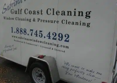 A white trailer with the words gulf coast cleaning written on it.