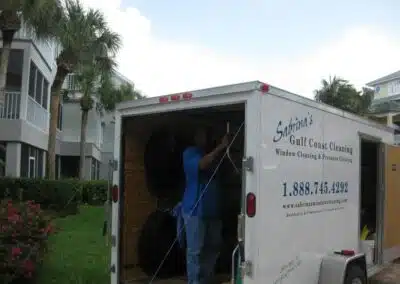A man standing in the back of a moving truck.