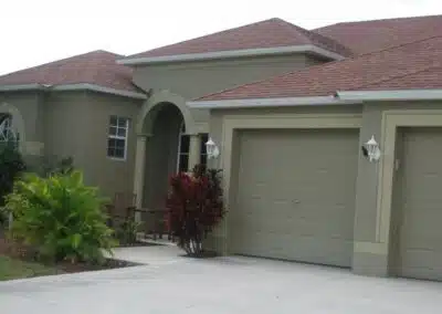 A house with a garage and driveway in front of it.